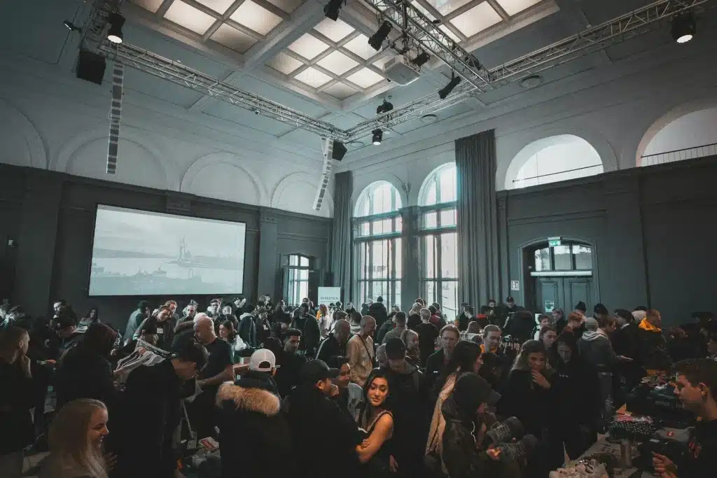 a large corpoate event in a big hall with lights and projector
